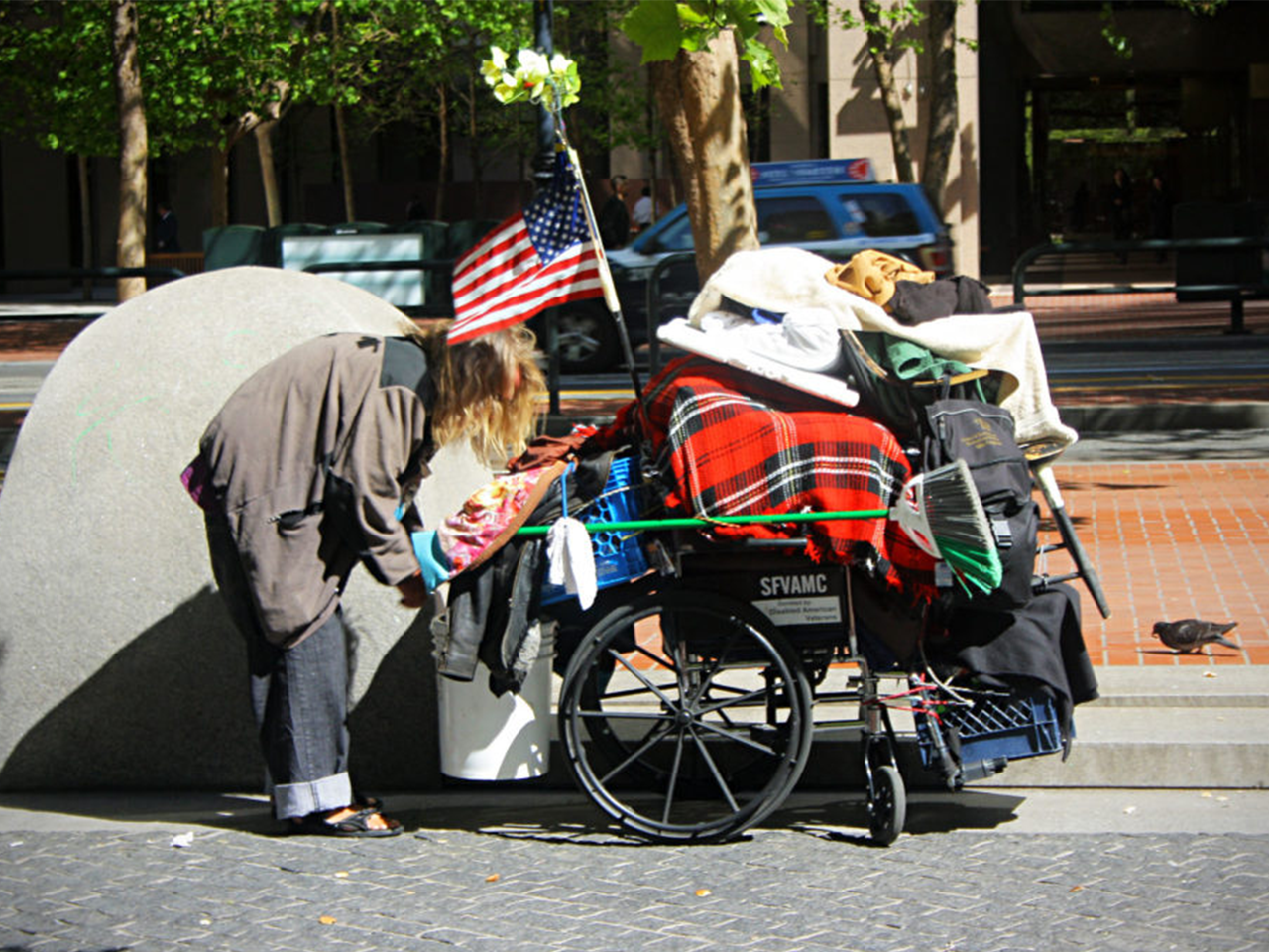 Photographie d'un américain pauvre avec ses affaires dans un chariot roulant