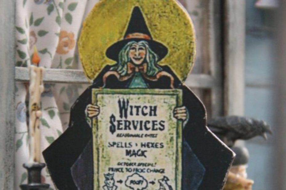 Objet décoratif représentant une sorcière avec une pancarte sur laquelle est proposé un service de transformation de prince en crapaud