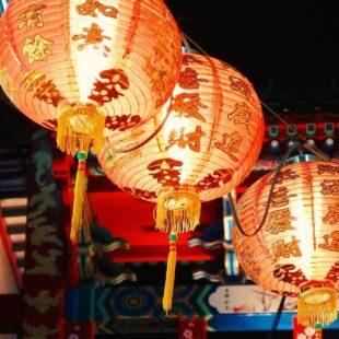 Trois lanternes japonaises allumées.